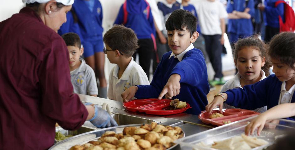 Students receive their lunch at Salusbury Primary School in northwest London